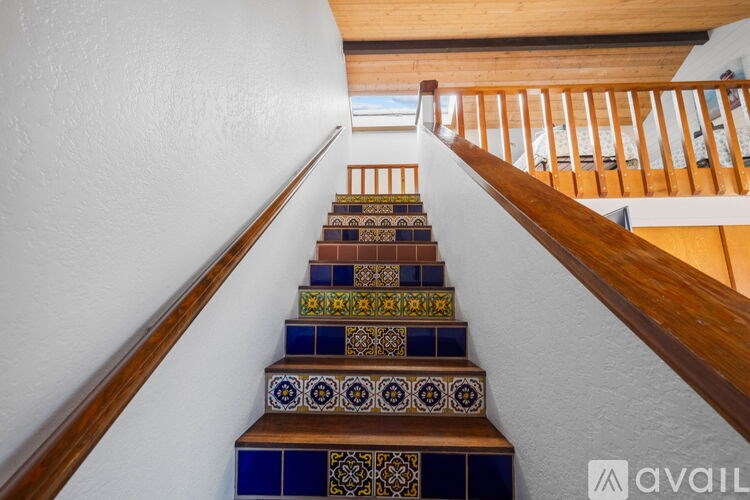 A staircase with a blue and brown tile design.