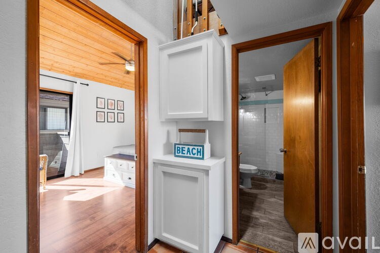 A kitchen with a refrigerator and a sign that says beach.