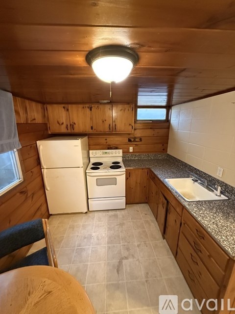 A small kitchen with a stove, oven, and sink.