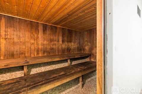 A wooden bench with a tiled floor underneath it.
