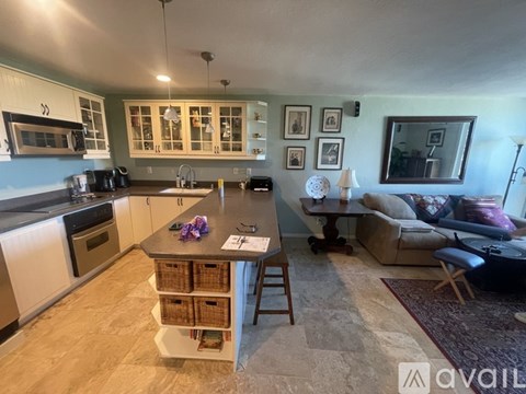 A kitchen with a table and chairs in the middle of the room.