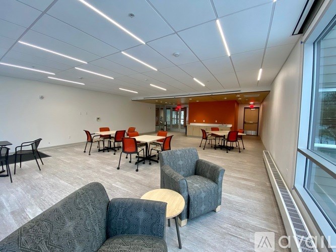 A conference room with a long table and chairs.