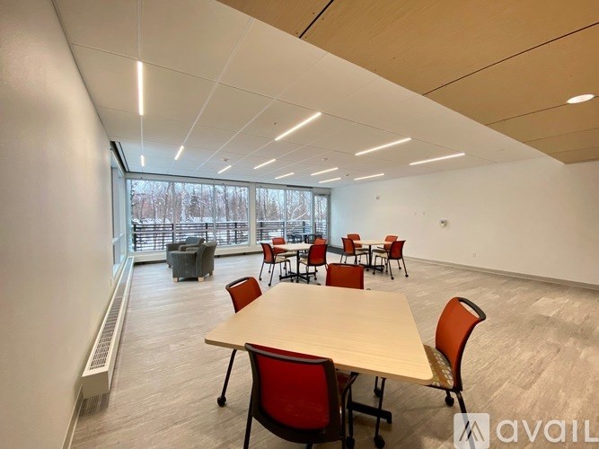 A conference room with a long table and chairs.