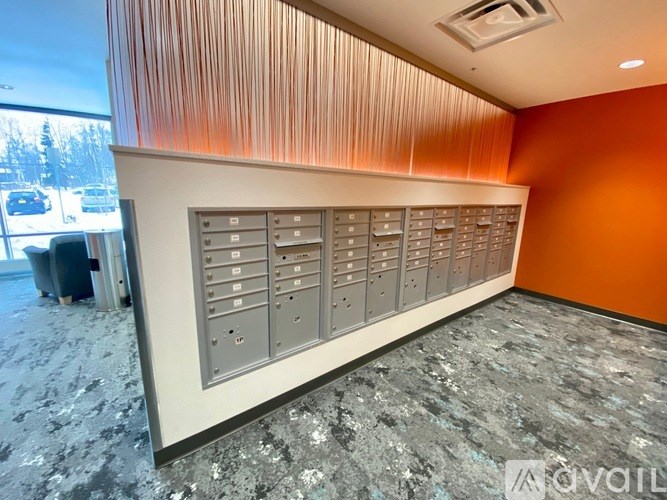 A row of mailboxes are lined up against a wall.