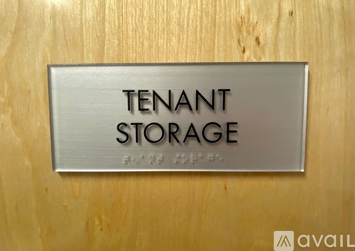 A sign that says "TENANT STORAGE" is mounted on a wooden wall.