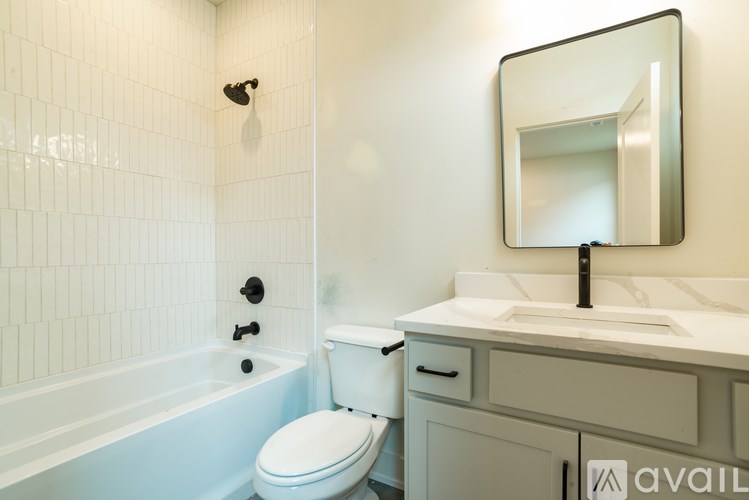 A bathroom with a toilet, sink, and bathtub.