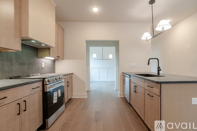 A kitchen with wooden cabinets and a black countertop.