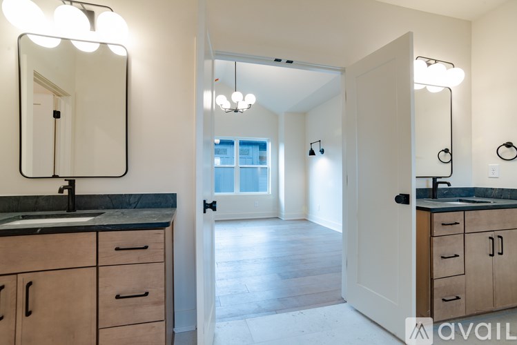 A bathroom with a sink, mirror, and wooden cabinets.