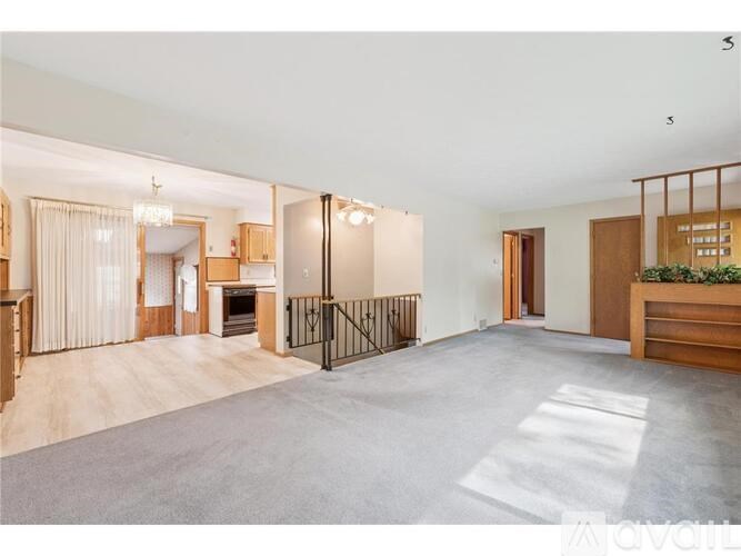 A spacious living room with a sliding door and a balcony.