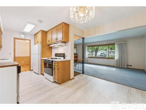 A kitchen with wooden cabinets and a white refrigerator.