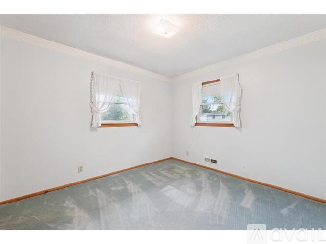 A room with two windows covered in plastic.