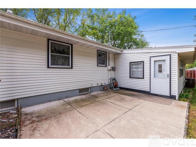 A house with a white door and two windows is for sale.