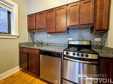 A kitchen with wooden cabinets and a stove top oven.