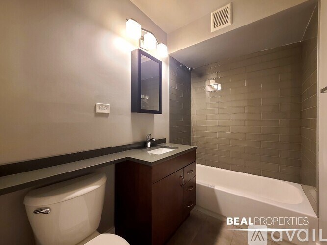 A bathroom with a toilet, sink, and bathtub.