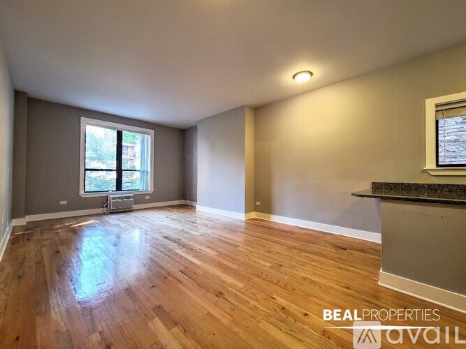 A room with wooden flooring and a window is available for rent.