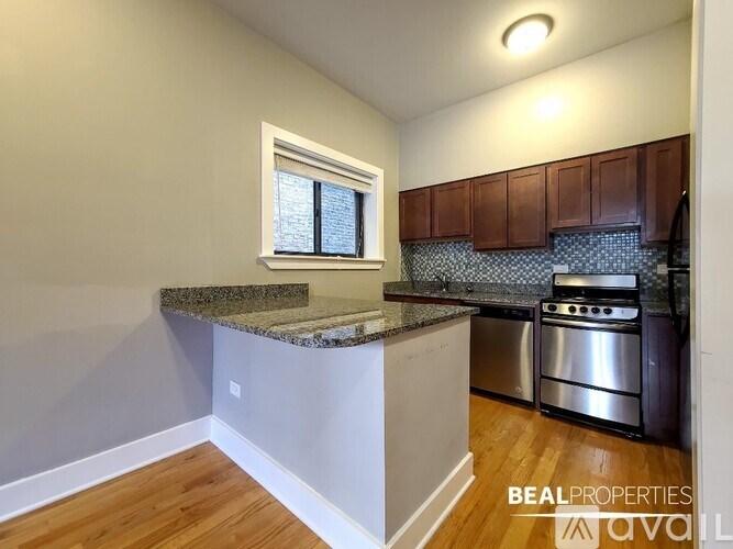A kitchen with a granite countertop and stainless steel appliances.