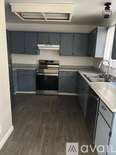 A kitchen with a stove top oven and a dishwasher.
