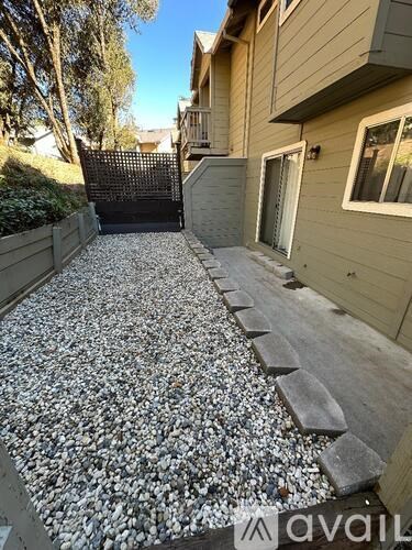 A gravel pathway leads up to a house.
