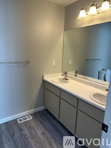 A bathroom with a sink and mirror.