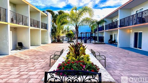 A balcony of a building with a view of the sky and trees.