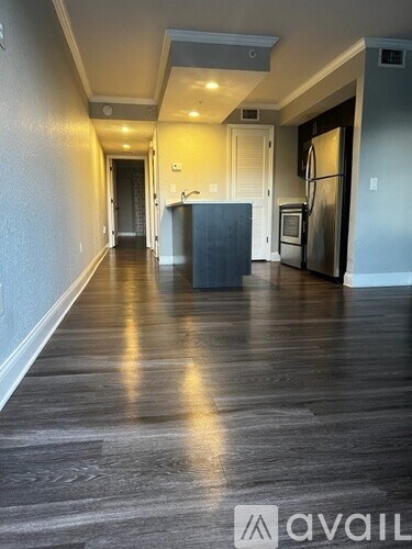 A long hallway with a kitchen at the end.