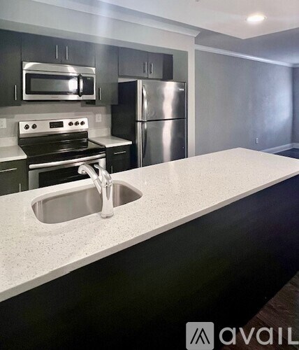 A kitchen with a stainless steel refrigerator and oven.