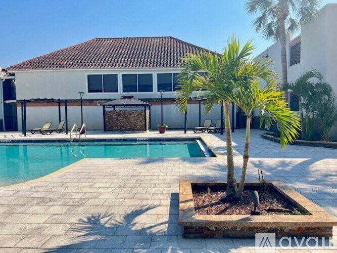 A palm tree is planted in a square planter.