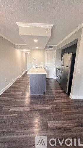 A kitchen with a refrigerator and a countertop.