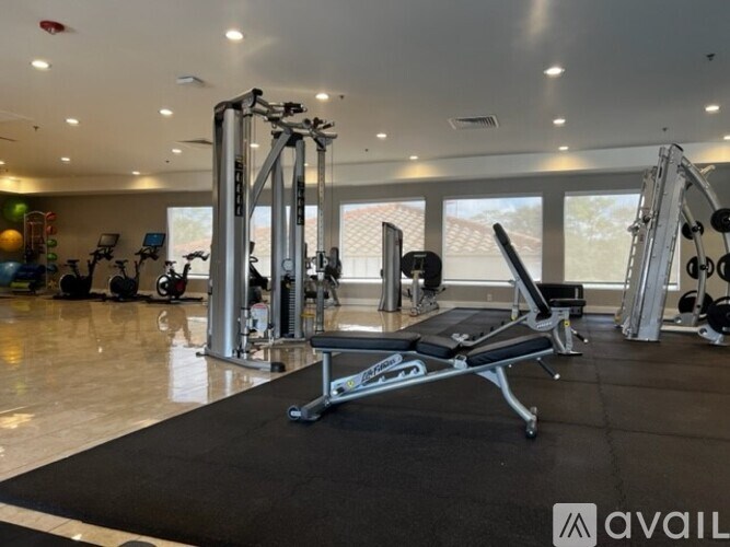 A gym with a variety of equipment including a leg press machine.