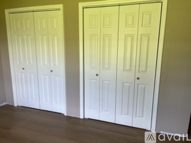 Two white doors in a room.