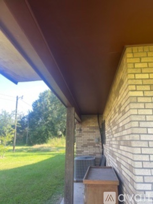 A wooden beam on a house with a brick wall.