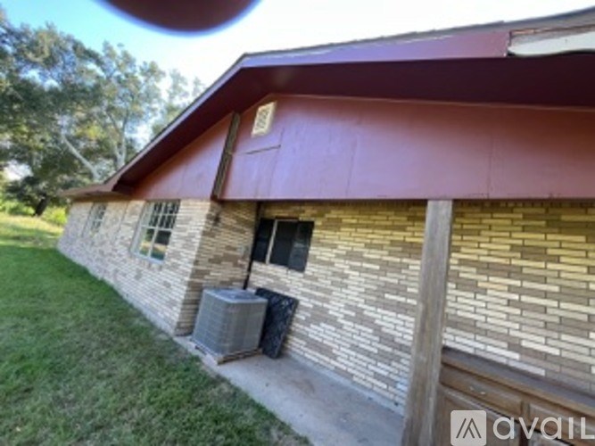 A house with a red roof and a brick wall.