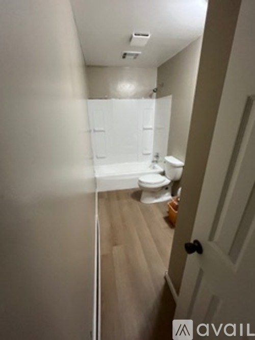 A bathroom with a toilet, sink, and bathtub.