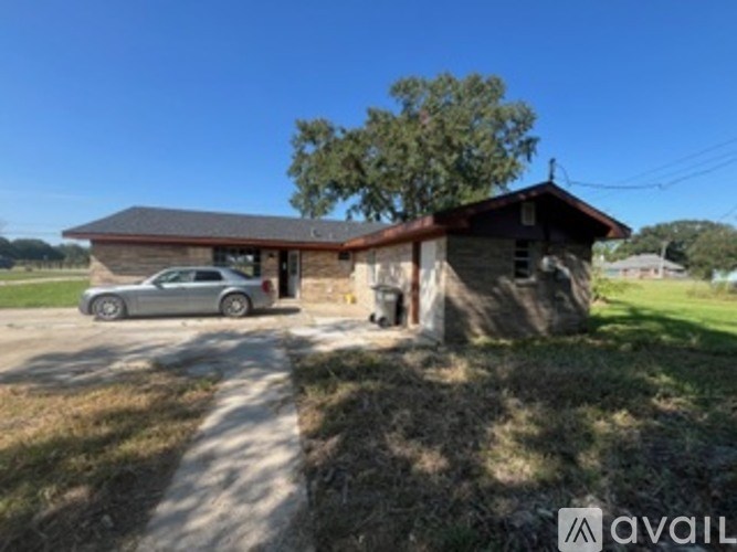 A house with a car parked in front.