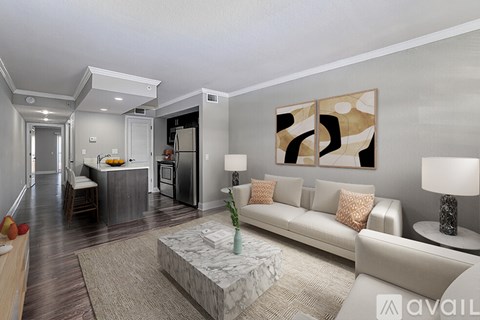 A modern living room with a white sofa and a marble coffee table.