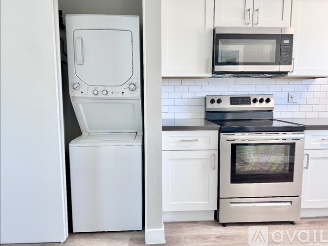 A white dishwasher is open in a kitchen.