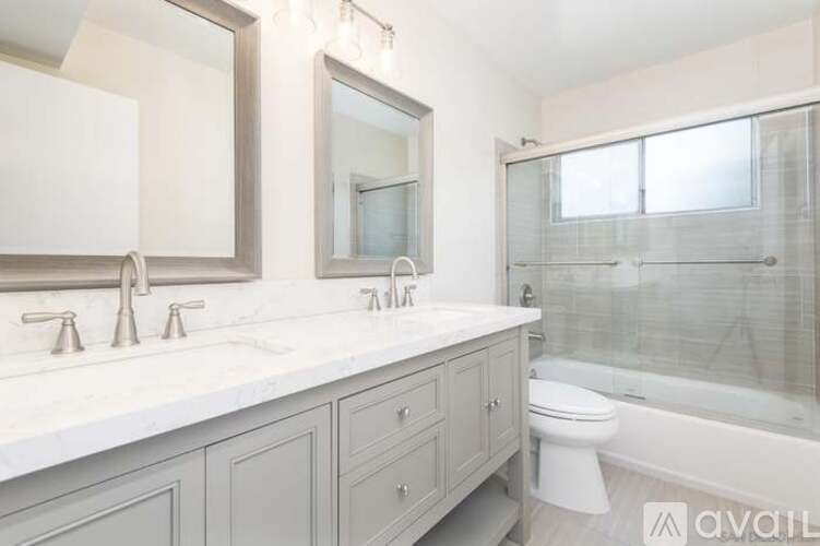 A bathroom with a white countertop and a white toilet.