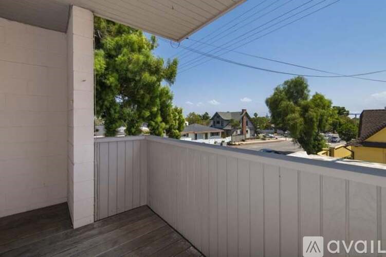 A balcony with a view of a residential area.