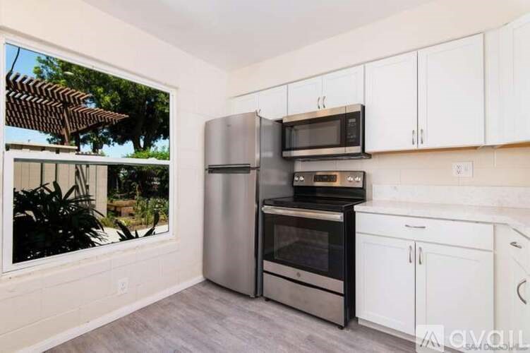 A kitchen with white cabinets and stainless steel appliances.