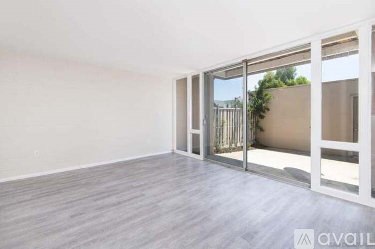 A room with a sliding glass door leading to a balcony.