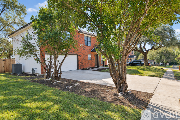 A red brick house with a white garage door.