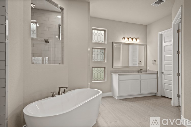 A white bathroom with a large tub and a vanity.