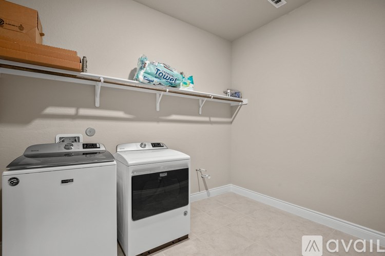 A small laundry room with a washer and dryer.