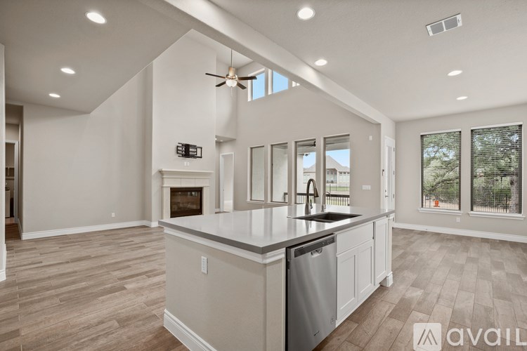 A spacious kitchen with a large island and a fireplace.