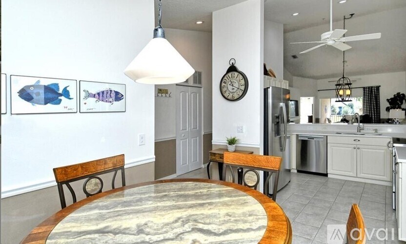 A kitchen with a table and chairs in the middle of the room.
