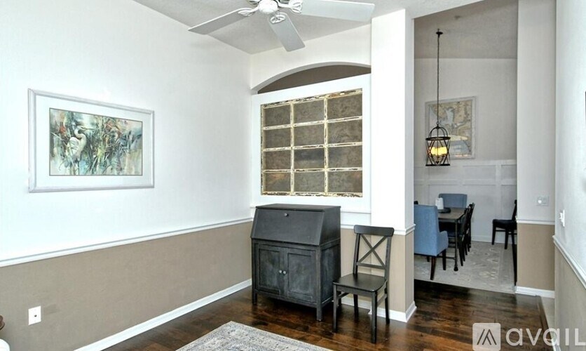 A room with a piano and chairs.