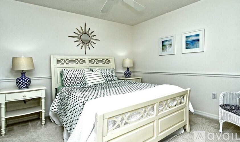 A bedroom with a bed, nightstand, and chair.