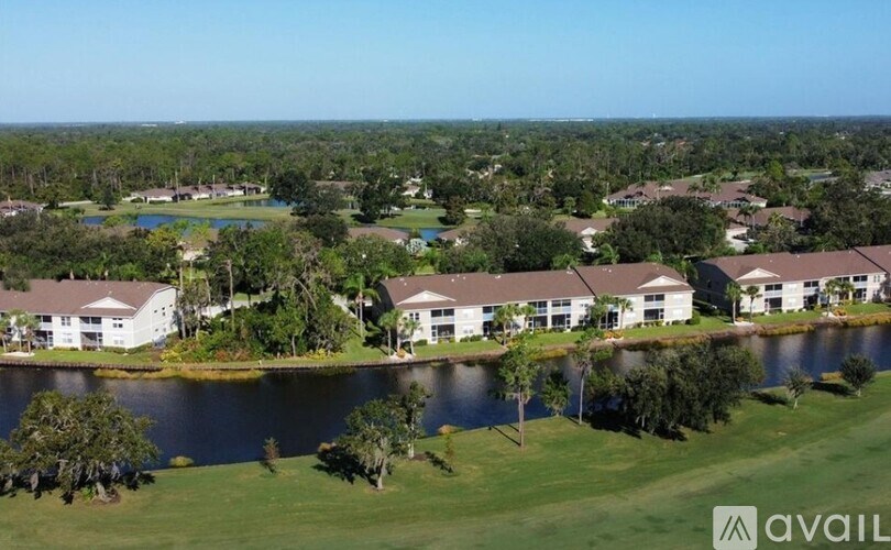 A bird's eye view of a residential area with houses and a lake.