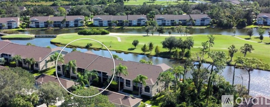A bird's eye view of a golf course surrounded by houses.