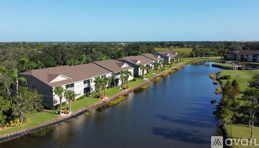 A row of houses are situated by a body of water.